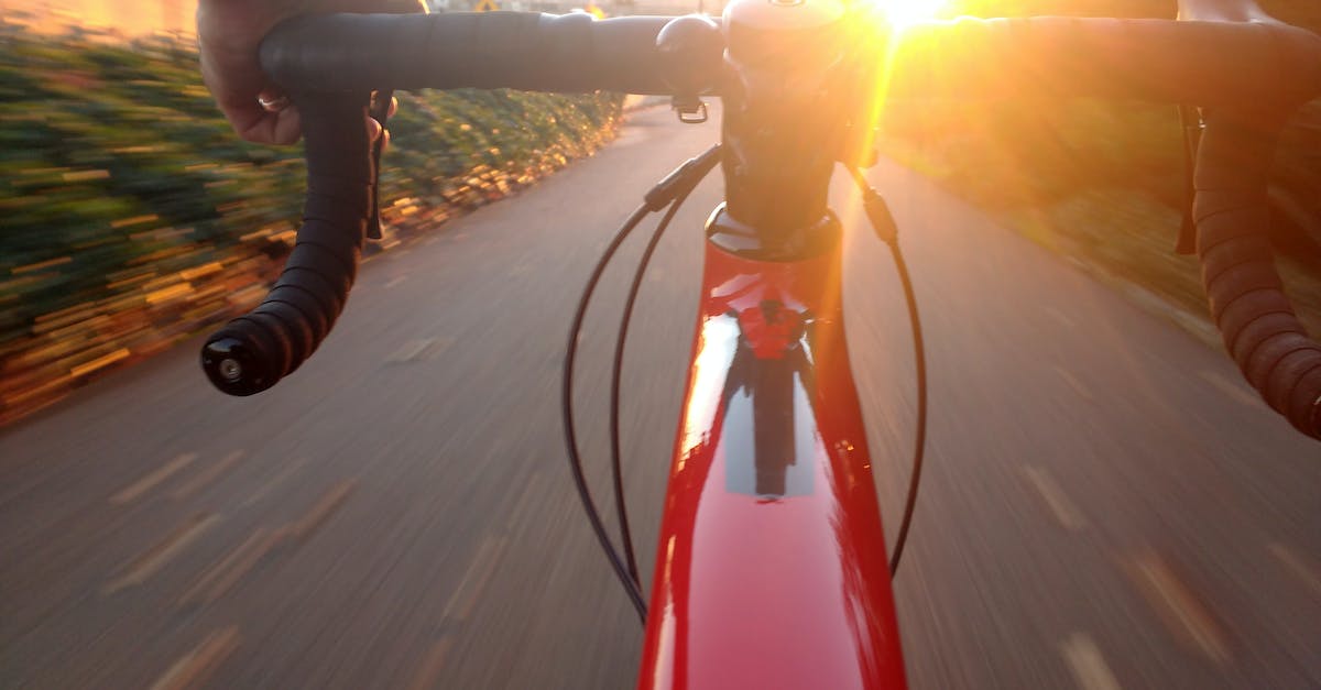 How to influence the day/light cycle? - Person Riding on Red Road Bike during Sunset