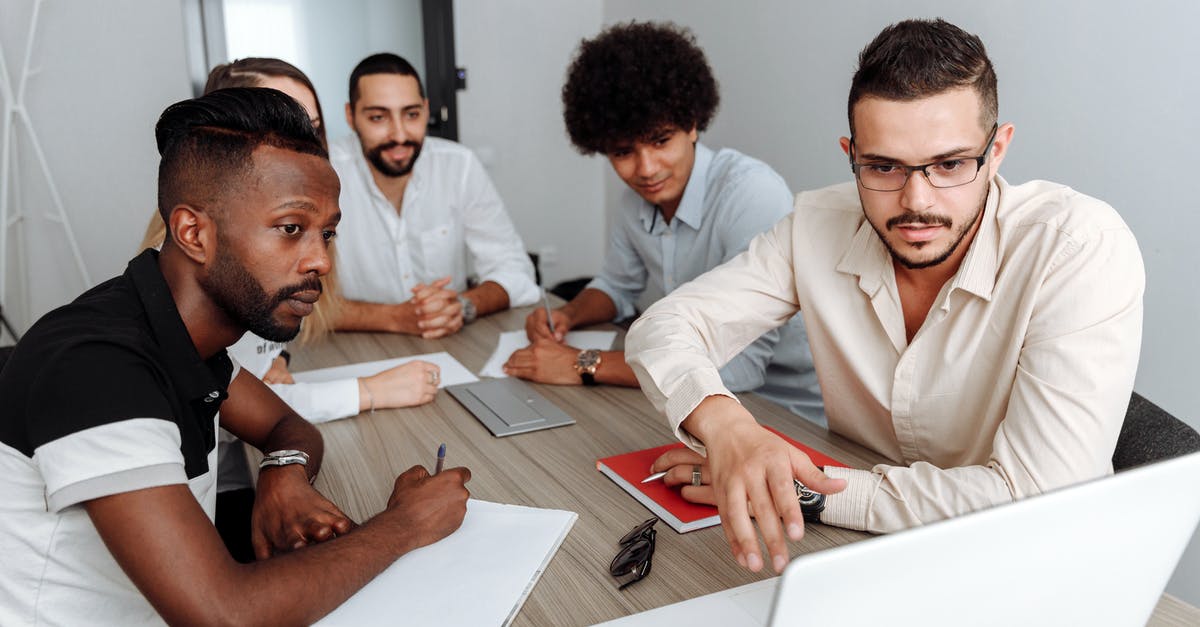 How to initiate cooperation requests in Death Stranding on PC? - Group of People in a Meeting Looking at a Laptop Screen