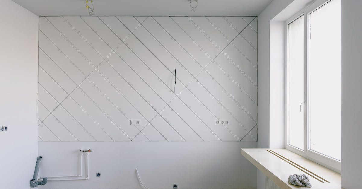 How to install mods for the new Minecraft launcher - Back view of unrecognizable workman in apron mounting window near drilling machine and doors in flat