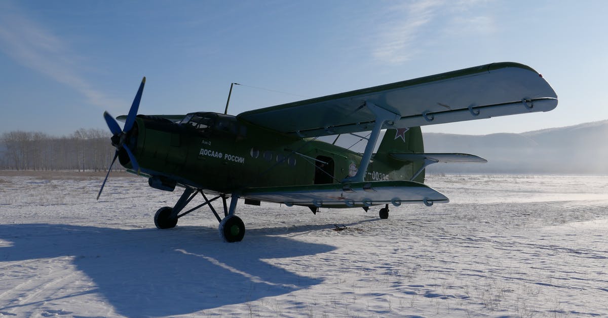 How to land accurately with a plane? - Soviet aircraft with propeller placed on snowy ground of airfield against cloudless blue sky on cold winter day in countryside