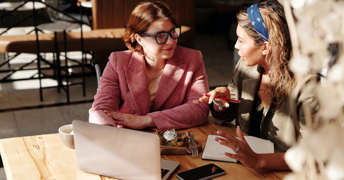 How to let two accounts to work with one device? - Woman in Red Blazer Sitting by the Table Having a Meeting