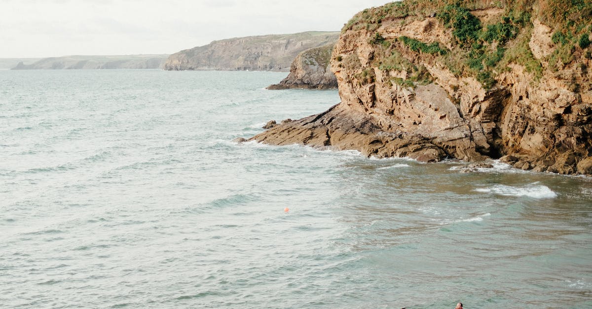 How to locate imprisoned lord to rescue him - Anonymous rescuers standing in sea near boat against overcast sky