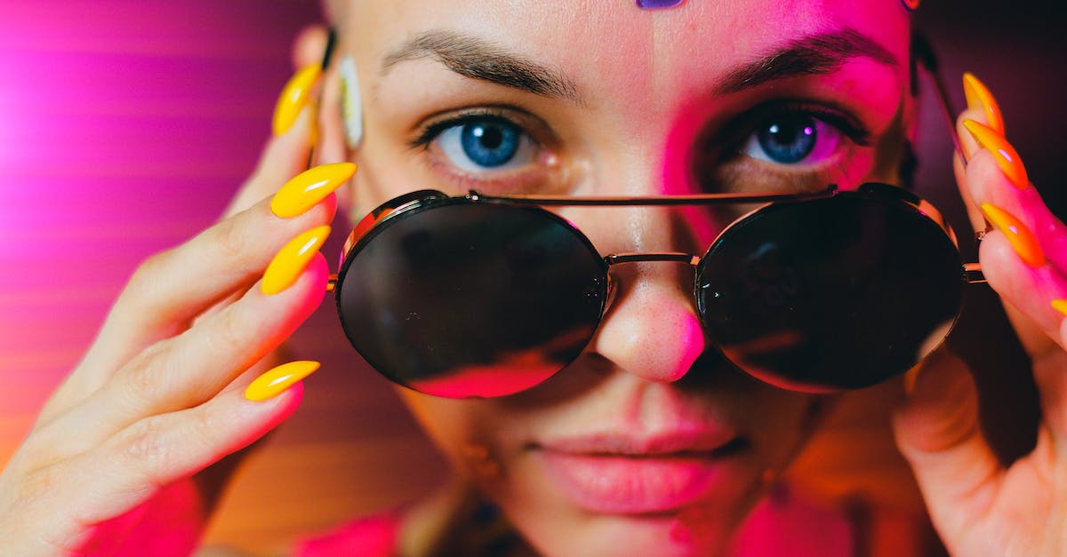How to lower infamy? - Crop bald woman with sticker on face lowering sunglasses How to lower infamy? - Crop bald woman with sticker on face lowering sunglasses