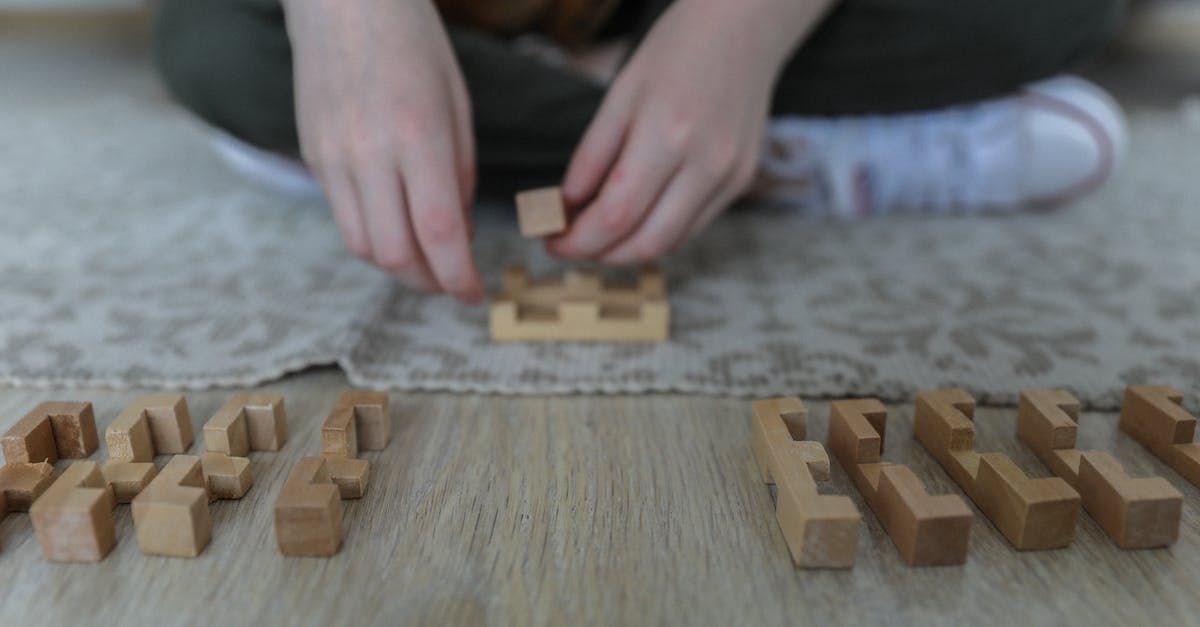How to make a block disappear after a certain period of time - Crop girl playing blocks on carpet
