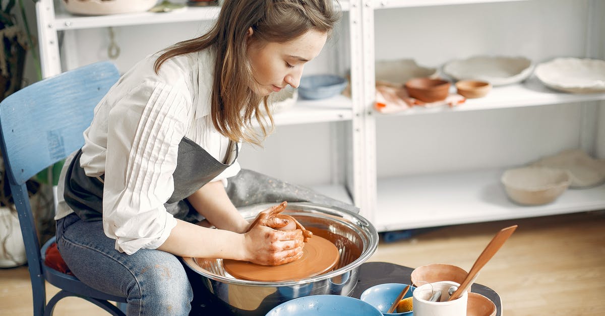 How to make a dockingport not detatch it self? - Woman forming clay bowl on pottery wheel