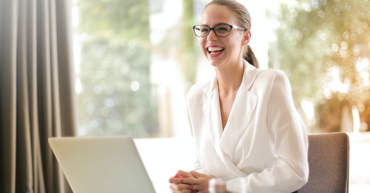 How to make a dwarf satisfied at work? - Laughing businesswoman working in office with laptop