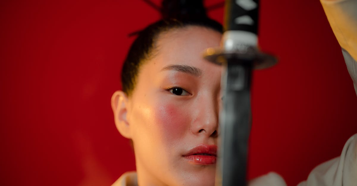 How to make a fireball shooting sword on vanilla Minecraft? - A Woman Holding a Katana