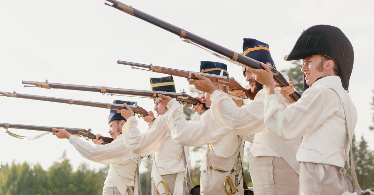How to make a sword that shoots particles that do damage? - Men in White Clothing and Black Hats Holding Rifle