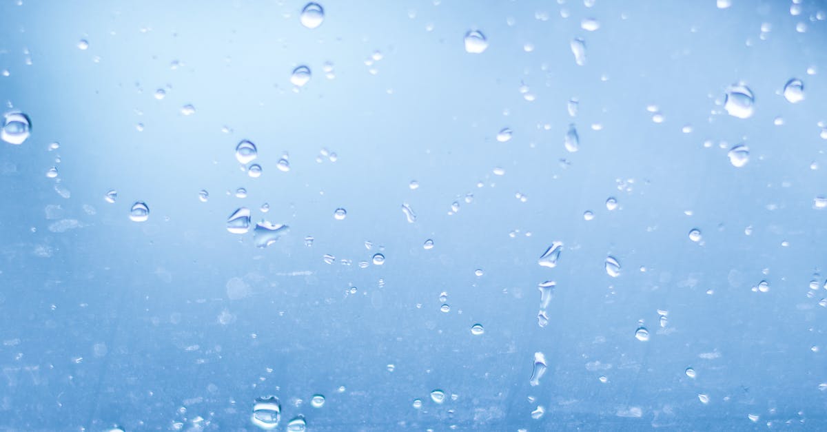 How to make clear glass windows? - Close-up of Water Droplets Against Blue Background How to make clear glass windows? - Close-up of Water Droplets Against Blue Background