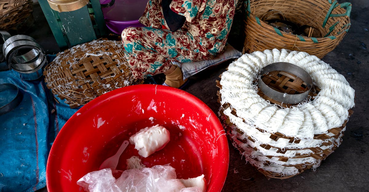 How to make @e look only in an object or mob name? - From above of tool for production of traditional Vietnamese noodles with white dough near plastic container and wicker basket