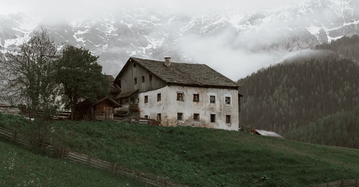 How to make snow golems do damage? - Weathered house located on rough grassy terrain near vast forest trees growing near mountain slope covered with snow in cloudy day