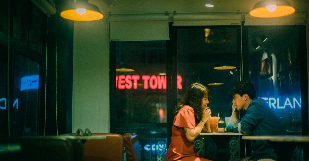 How to make sure a night date doesn't continue to the bedroom? - Asian couple drinking cocktails in cafe at night