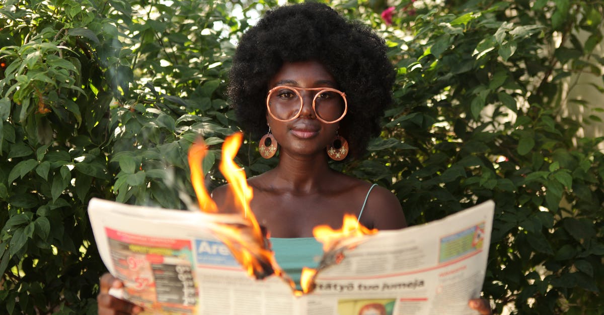 How to make zombies/skeletons not burn in sunlight without changing their looks? - Trendy black woman reading burning newspaper in garden How to make zombies/skeletons not burn in sunlight without changing their looks? - Trendy black woman reading burning newspaper in garden