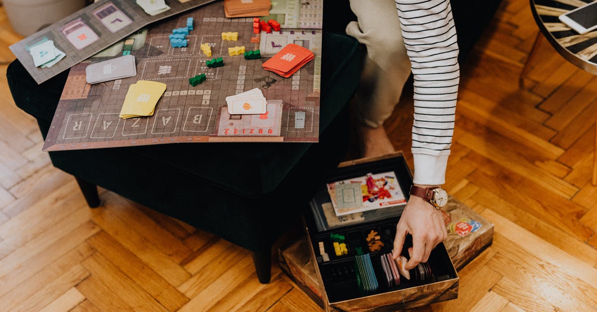 How to most efficiently manage excess cards when upgrading in Clash Royale? - Person in White and Black Striped Long Sleeve Shirt Standing Beside Brown Wooden Table