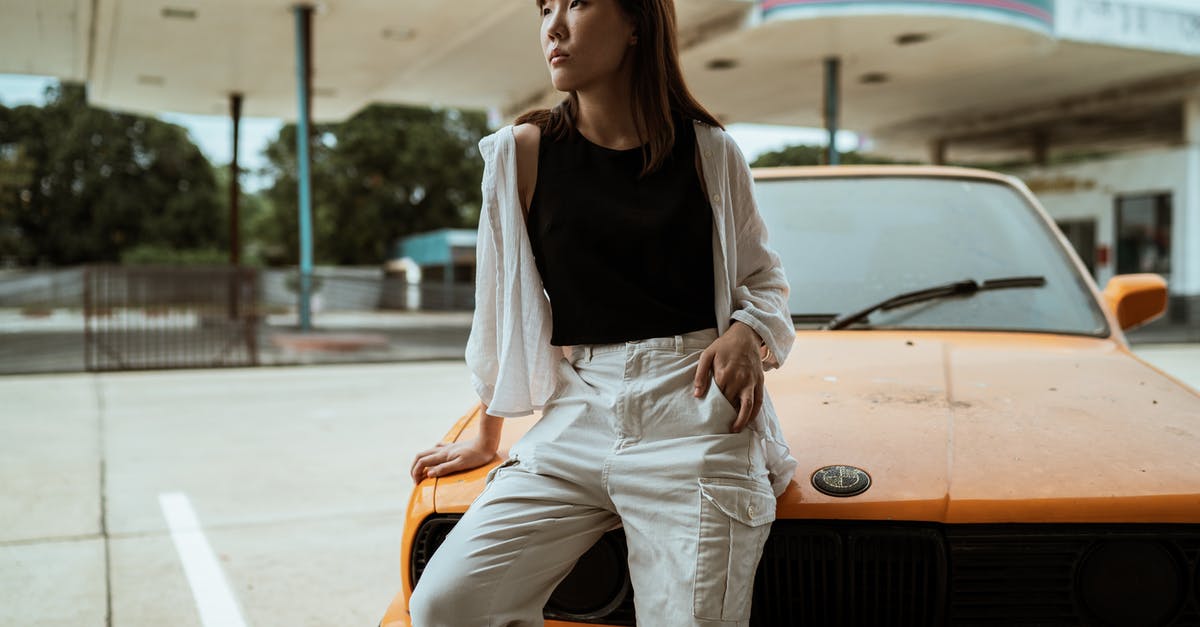 How to peacefully remove space station - Slim pensive Asian woman in casual wear sitting with hand in pocket on old timer automobile parked on asphalt road and looking away How to peacefully remove space station - Slim pensive Asian woman in casual wear sitting with hand in pocket on old timer automobile parked on asphalt road and looking away