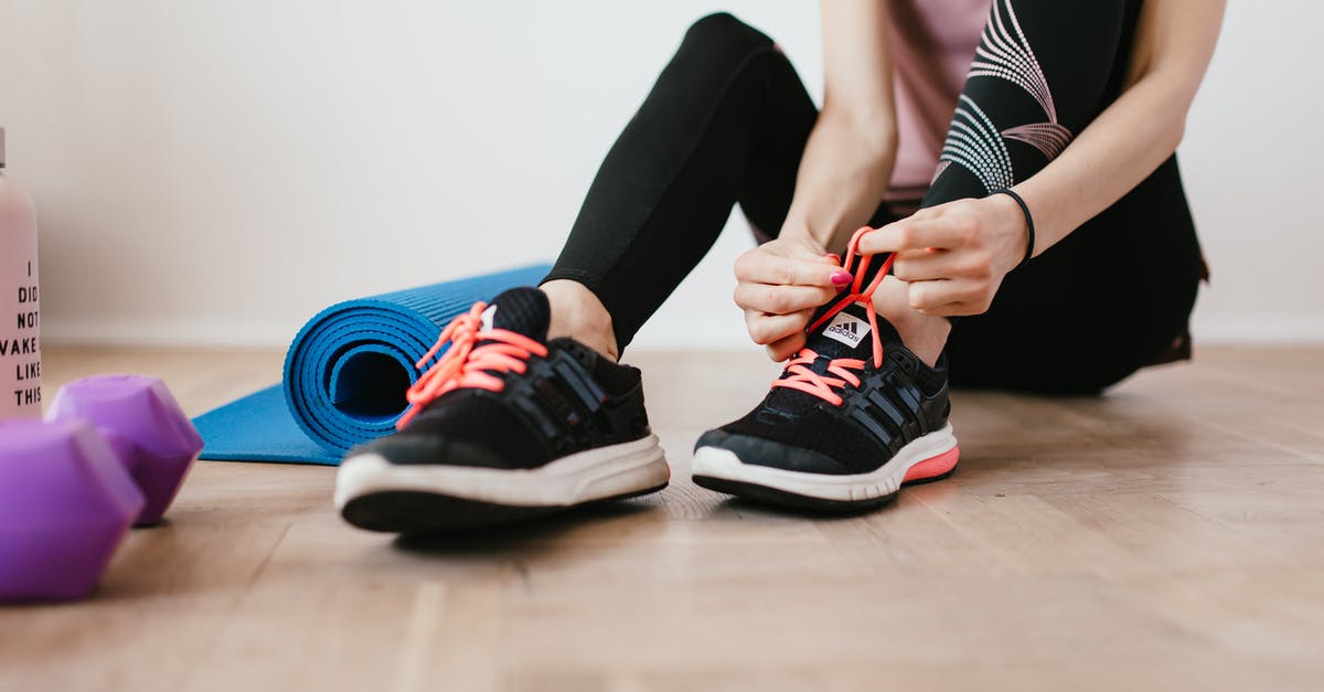 How to perform torture attacks? - Anonymous slender female athlete tying shoelaces near sport accessories