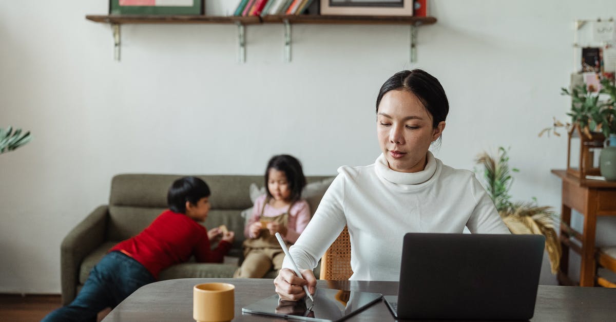How to play Project M using a backup on USB? - Focused young Asian mother working remotely while children playing on sofa How to play Project M using a backup on USB? - Focused young Asian mother working remotely while children playing on sofa