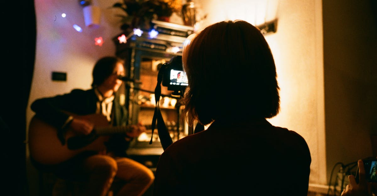 How to play Rocksmith 2014 Remastered on Linux using the USB guitar adapter? - Unrecognizable female recording video of friend playing guitar on camera in flat with shiny garlands How to play Rocksmith 2014 Remastered on Linux using the USB guitar adapter? - Unrecognizable female recording video of friend playing guitar on camera in flat with shiny garlands