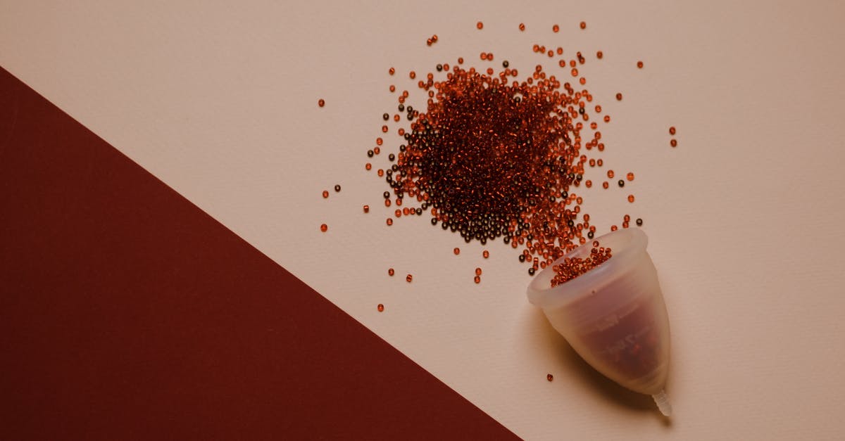 how to prevent the commandblock from saying [@] [duplicate] - Top view of silicone menstrual cup with red beads scattered on pink surface