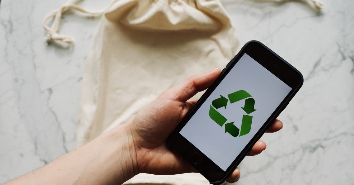 How to prevent the second World War as Hitler - Faceless person showing recycle symbol on mobile phone screen