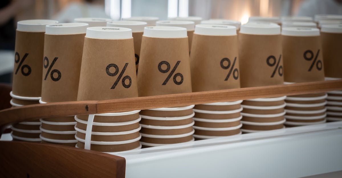 How to properly dispose of refuse - Stack of similar disposable cups with printed percent sign placed on counter in modern coffee shop How to properly dispose of refuse - Stack of similar disposable cups with printed percent sign placed on counter in modern coffee shop