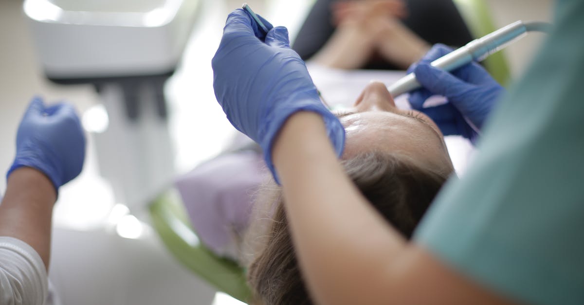 How to properly use the core drill ability of DWAARP? - Anonymous dentist using drill and mouth mirror for dental treatment