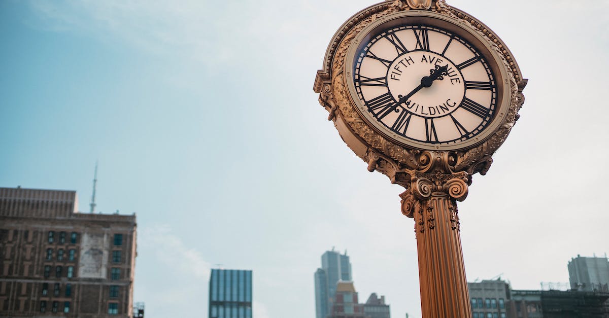 How to put a redstone block in clock mode? - From below of aged metal clock tower located in city center with high towers How to put a redstone block in clock mode? - From below of aged metal clock tower located in city center with high towers