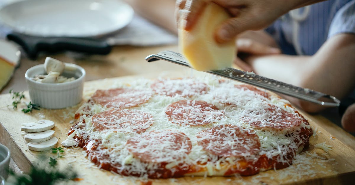 How to put Pokemon into Pokeball? [closed] - Unrecognizable person grating cheese on pizza