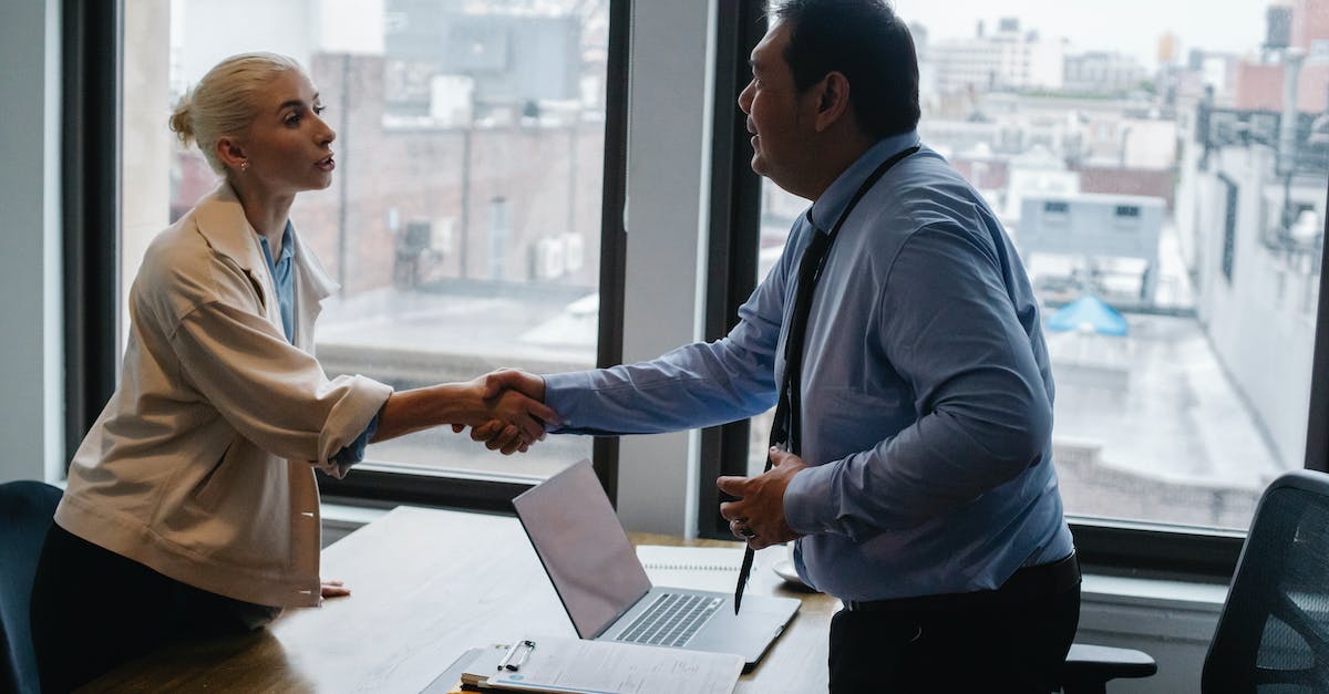 How to recruit sailors? - Young woman shaking hands with boss after business presentation