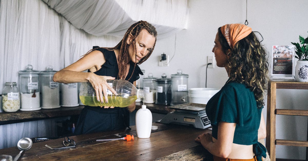 How to refill my stock of Samum Bombs? - A Woman Refilling a Plastic Bottle with Liquid Soap