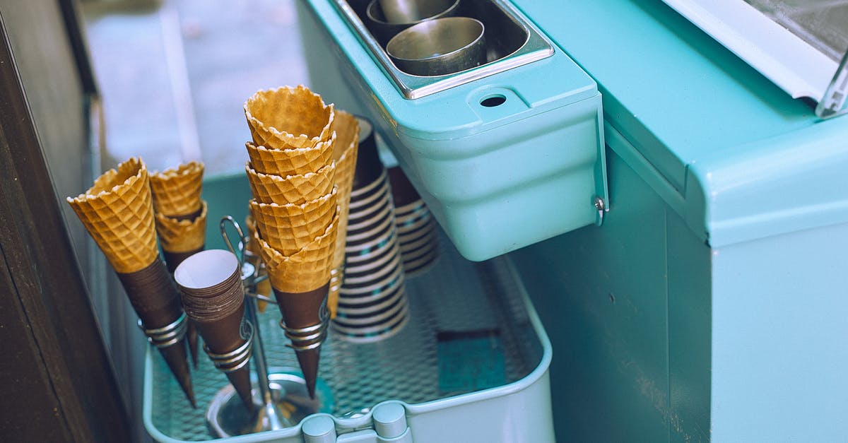 How to remove all items from Steam store cart? - From above of light blue ice cream cart equipped with metal glasses with scoop above basket with waffle cones and paper cups