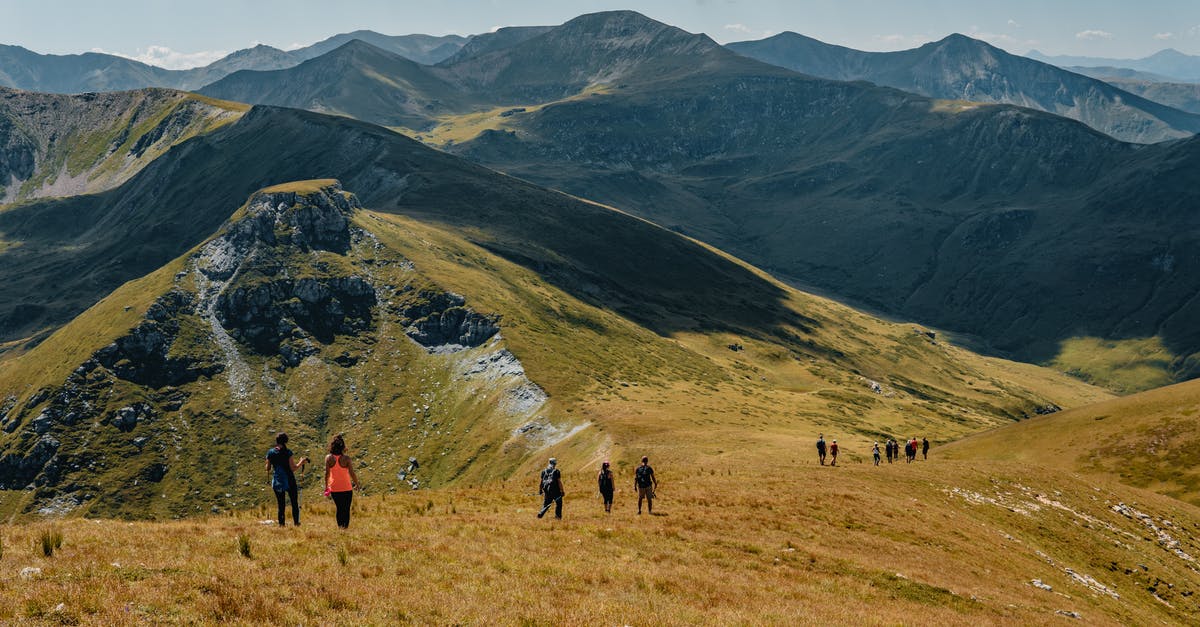 How to remove extreme hills grass - Picturesque landscape of rocky mountainous terrain covered with green grass with group of hiking travelers How to remove extreme hills grass - Picturesque landscape of rocky mountainous terrain covered with green grass with group of hiking travelers