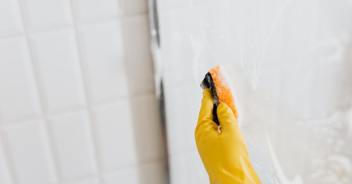 How to remove noble prisoners from dead factions? - From above of crop anonymous person in yellow rubber protective glove washing shower cabin glass with sponge and detergent How to remove noble prisoners from dead factions? - From above of crop anonymous person in yellow rubber protective glove washing shower cabin glass with sponge and detergent