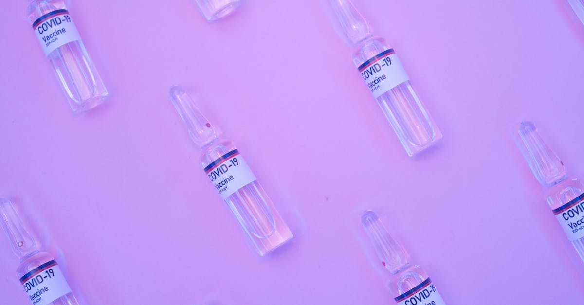 How to repeat glitch that turns med vendors into gun vendors? - Background of similar ampoules with COVID 19 vaccine placed on table under neon purple light