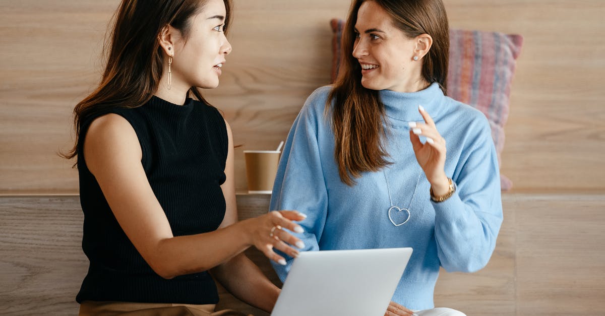 How to reply the last whisper (MP) in chat - Young multiethnic business partners speaking about strategy of job while browsing netbook in contemporary workplace