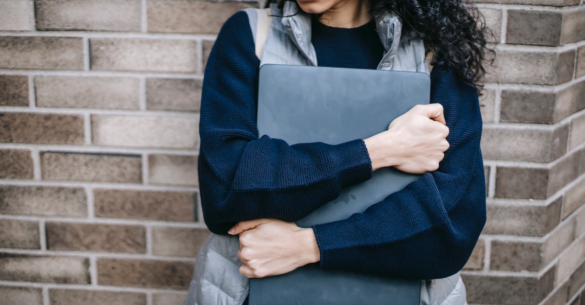 How to re-route save folder destination - Crop anonymous ethnic female in casual outfit with folder near brick wall of building How to re-route save folder destination - Crop anonymous ethnic female in casual outfit with folder near brick wall of building