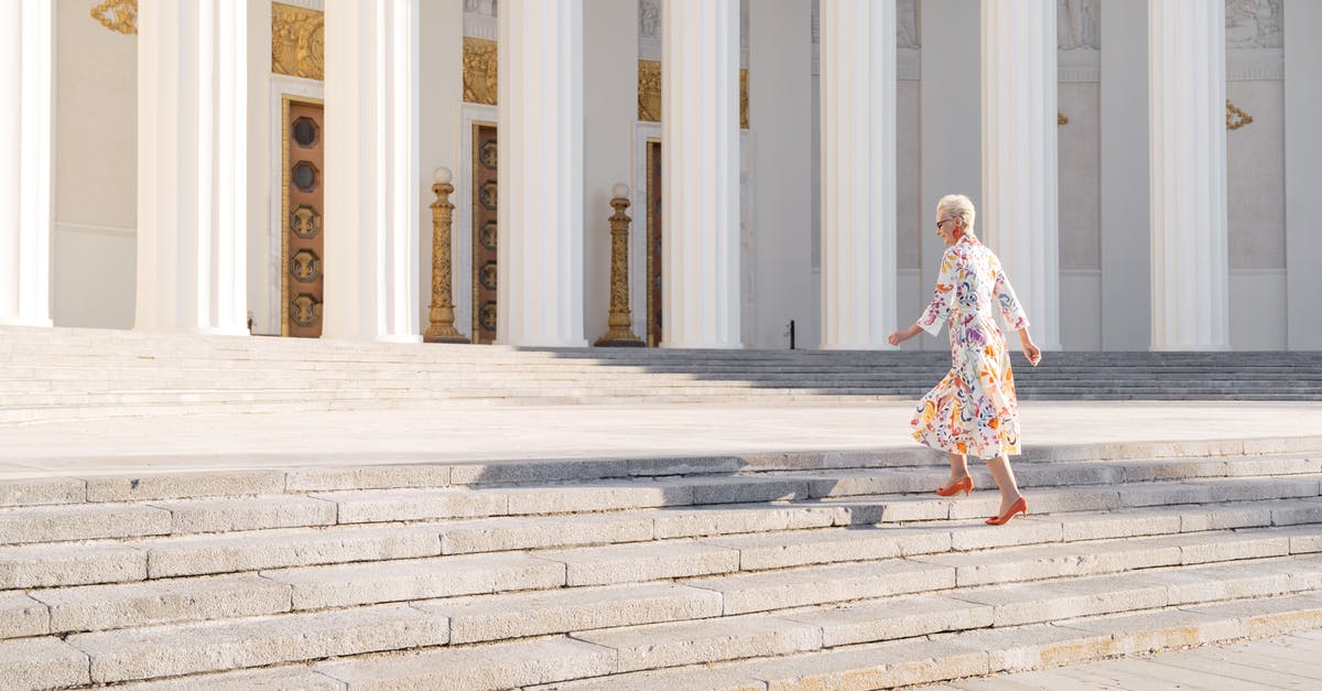 How to revive outside of combat? - Woman in White and Brown Floral Dress Walking on Gray Concrete Stairs