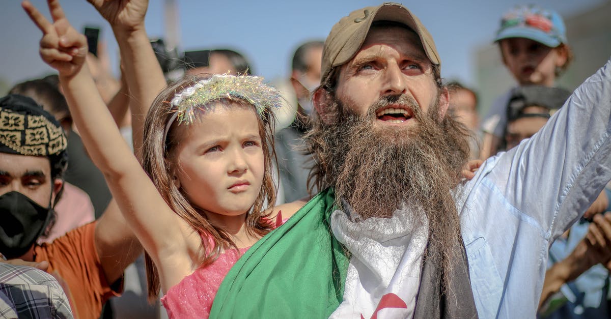 How to score victory against government in exile? - Ethnic bearded man with kid at protest