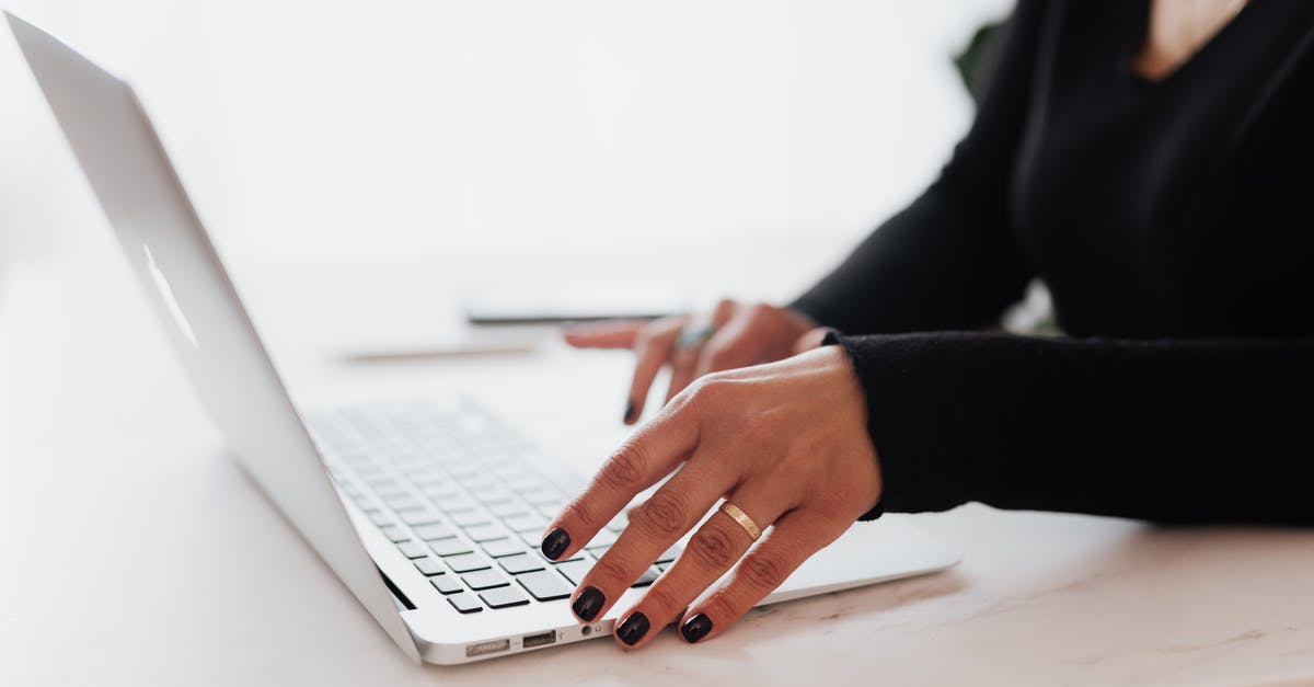 How to scroll sideways on morph menu? - Crop unrecognizable female entrepreneur in casual clothes using touchpad on laptop while working at table in contemporary office