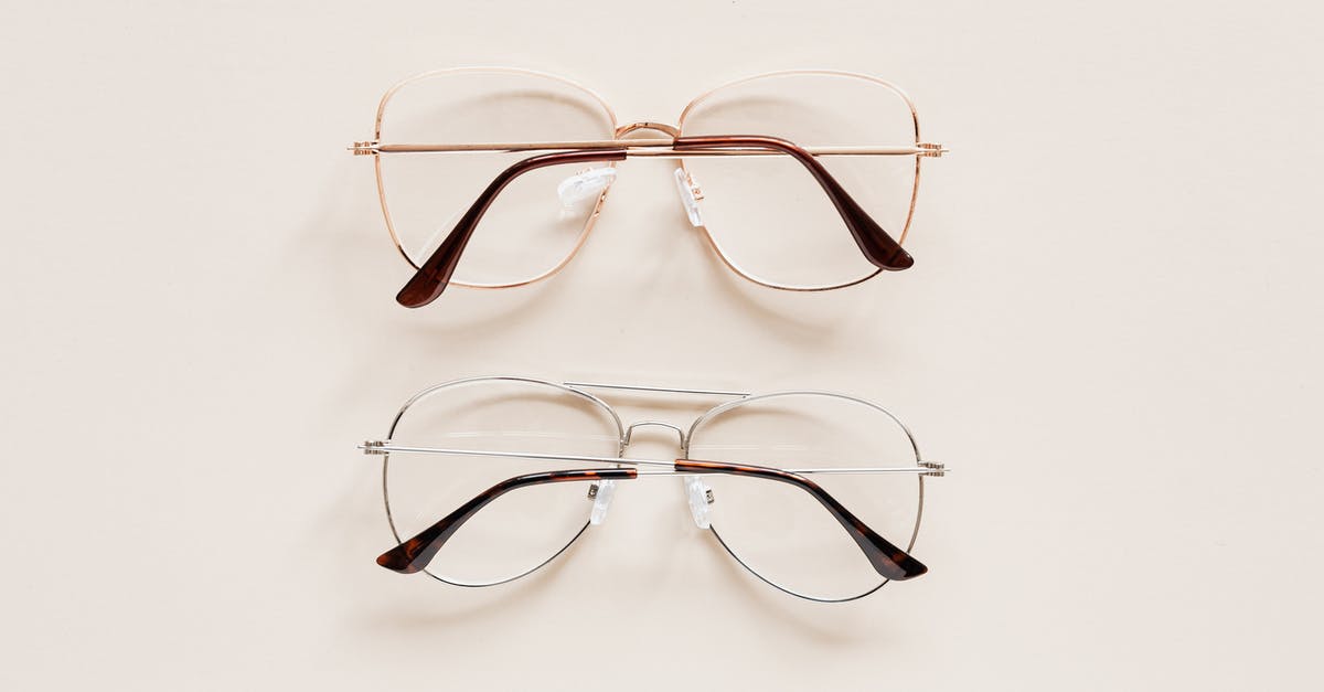 How to see past war table missions? - From above of fashion spectacles for vision with golden and silver metal shells placed on white table How to see past war table missions? - From above of fashion spectacles for vision with golden and silver metal shells placed on white table