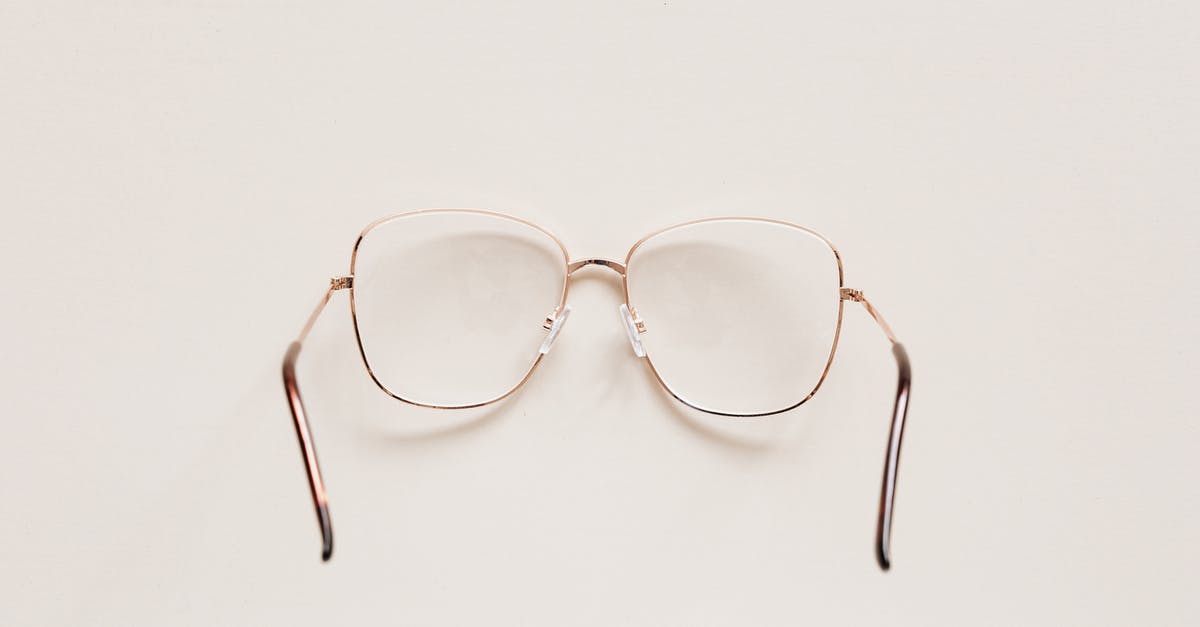 How to see past war table missions? - Top view of fashion spectacles with transparent optical lenses in golden metal shell placed on white table