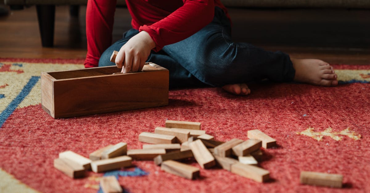 How to set hero build in Arcade game in Dota2? - Unrecognizable barefoot kid playing jenga at home