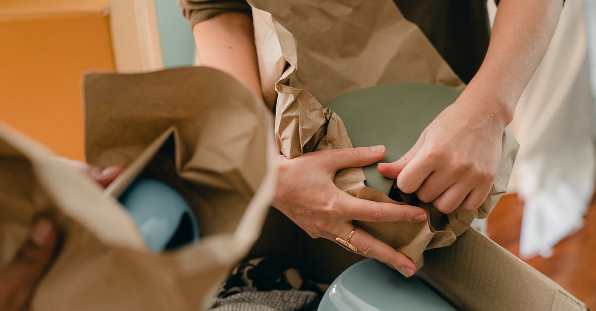 How to set new players into a team? - Crop unrecognizable person packing ceramic tableware in parchment How to set new players into a team? - Crop unrecognizable person packing ceramic tableware in parchment