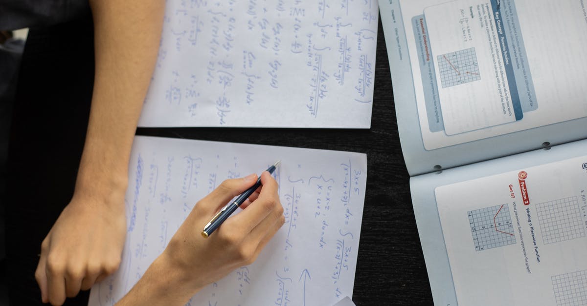 How to Solve Glitch Preventing Me From Attacking! - Top view of anonymous person with pen taking notes on piece of paper while solving equations in classroom during lesson