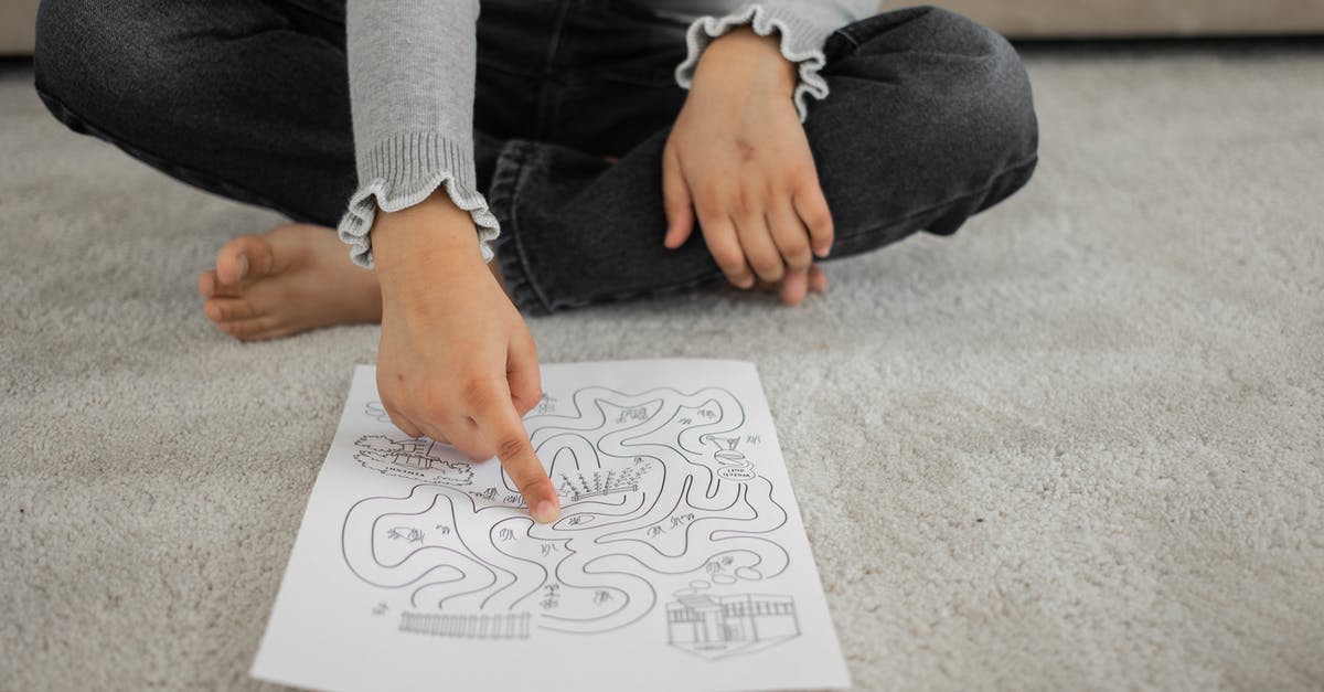 How to solve rat riddle in Shido's palace? - Crop anonymous barefooted child sitting on floor with crossed legs and solving labyrinth puzzle at home How to solve rat riddle in Shido's palace? - Crop anonymous barefooted child sitting on floor with crossed legs and solving labyrinth puzzle at home