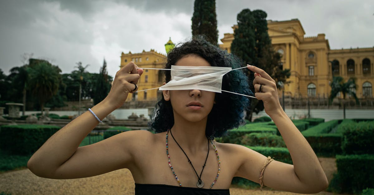 How to spawn rebel citizen medic? - Serious young ethnic female with curly hair in light top covering eyes with medical mask while standing in city park against cloudy sky How to spawn rebel citizen medic? - Serious young ethnic female with curly hair in light top covering eyes with medical mask while standing in city park against cloudy sky