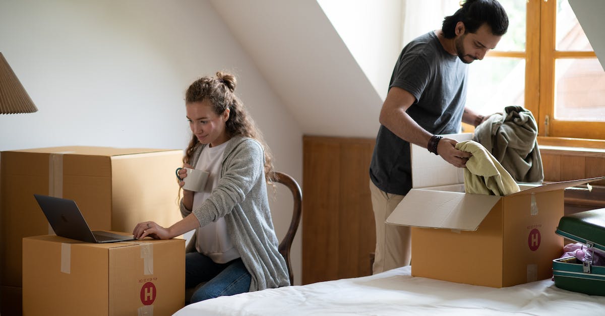 How to stack runes of same type? - Pensive female surfing internet on netbook and drinking coffee while ethnic man unpacking belongings from cardboard box after moving into new attic style house