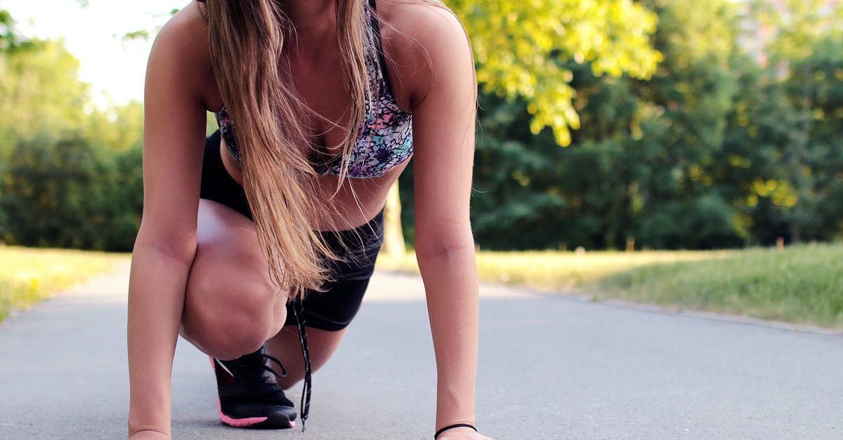 How to start with the most Health? - Women's Wearing Purple Floral Brassiere Holding Gray Concrete Pathway during Day Time