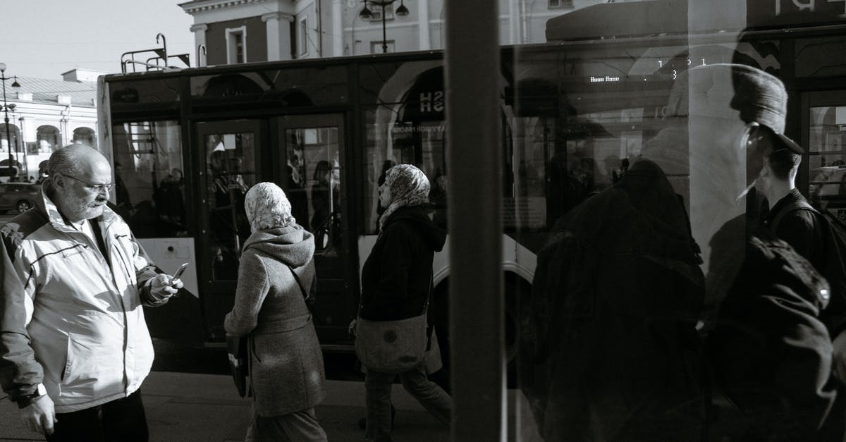 How to stop the killed entities message in Minecraft Java using a command block? [duplicate] - Black and white of unrecognizable people walking on pavement against trolleybus and old building in town in sunlight