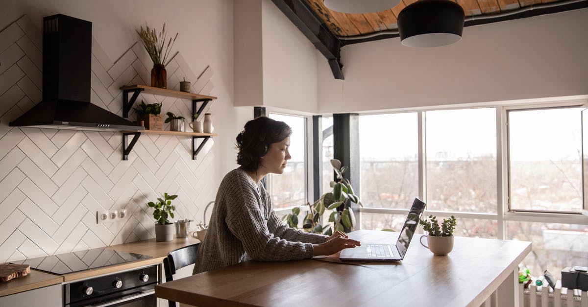 How to stop the killed entities message in Minecraft Java using a command block? [duplicate] - Side view of young female in casual clothes typing message on laptop while sitting at wooden table in kitchen